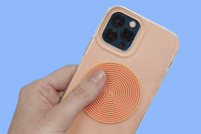 Speks Slabs circle groove orange sensory sticker on a phone